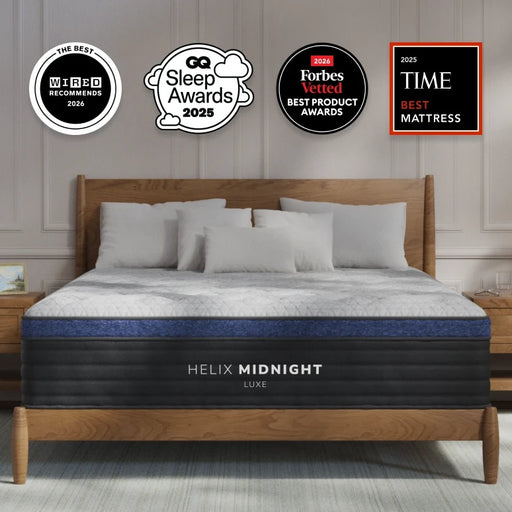 Helix Midnight mattress on a bed with various awards displayed above, in a bedroom setting.